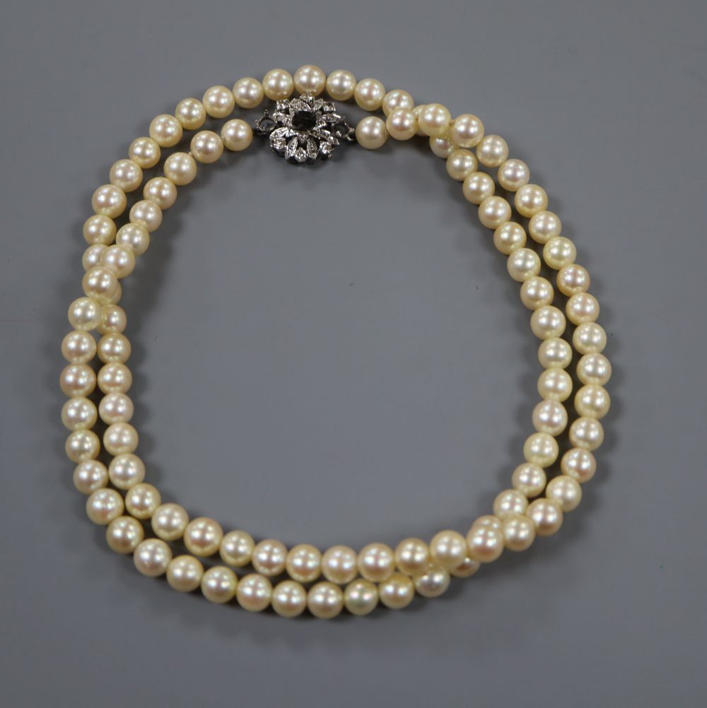 A single strand cultured pearl necklace with diamond set clasp (central stone missing), 72cm.